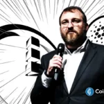 Charles Hoskinson speaking on stage with Midnight and Cardano visuals behind him