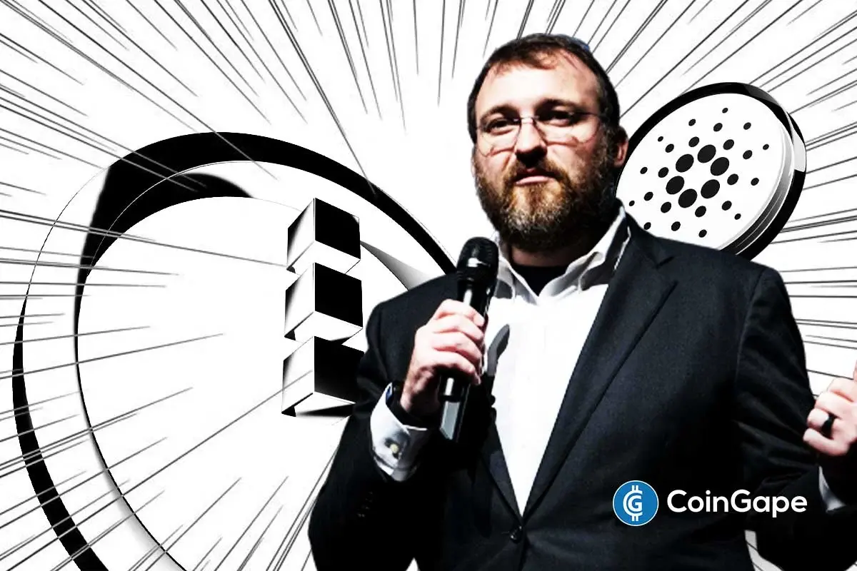 Charles Hoskinson speaking on stage with Midnight and Cardano visuals behind him