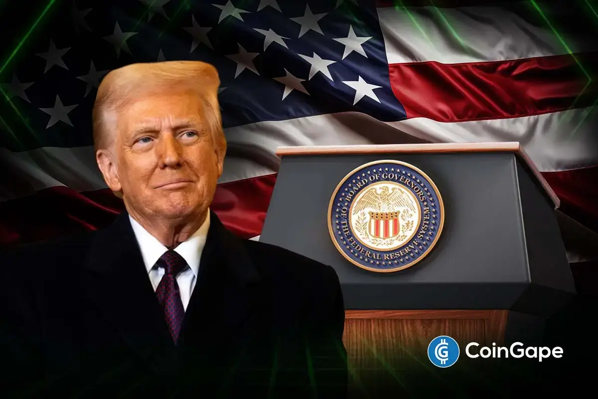 Trump stands before U.S. flag and Fed podium as anticipation builds for his 2026 Federal Reserve Chair announcement.