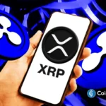 Smartphone displays XRP logo as Ripple expands enterprise treasury payments and cross-border settlement infrastructure.