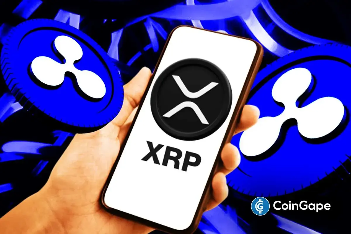 Smartphone displays XRP logo as Ripple expands enterprise treasury payments and cross-border settlement infrastructure.