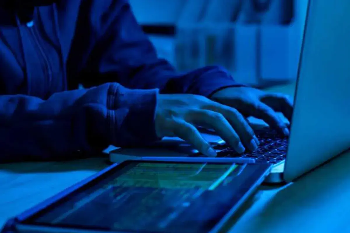 A person using laptop in blue light background