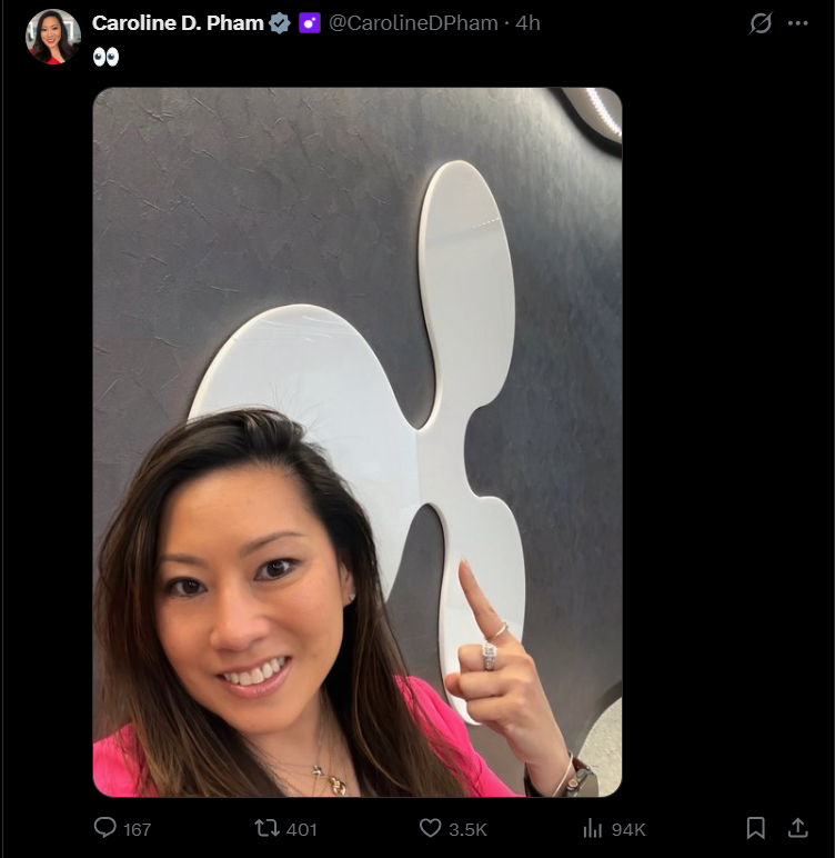 Caroline Pham Pointing at Ripple Logo